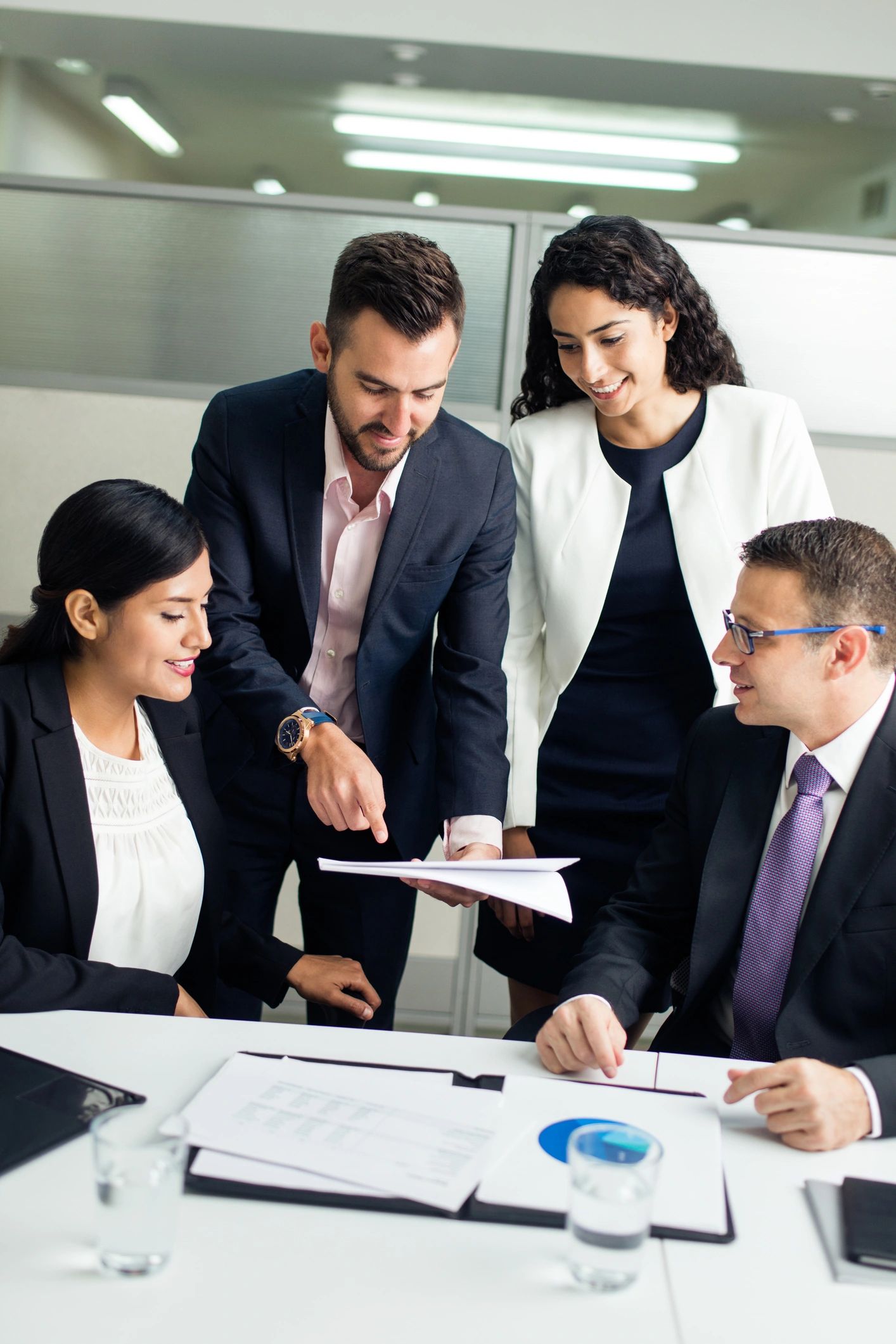 Executive presenting a document to colleagues in a meeting
